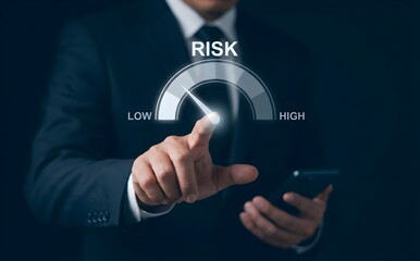 Fototapeta premium Person in a suit is touching a digital risk meter pointing to 