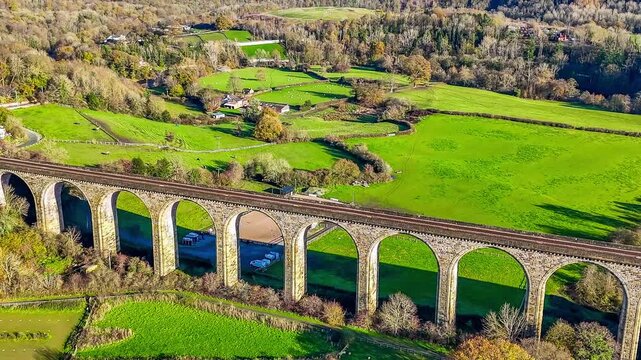 A receding aerial view flying away from close to the cefn viaduct near Chirk, Wales
