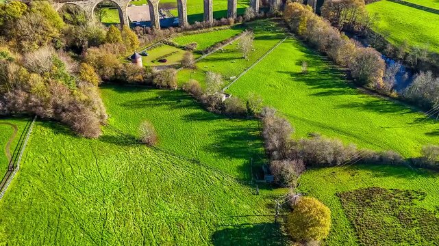An aerial view panning up towards the cefn viaduct near Chirk, Wales