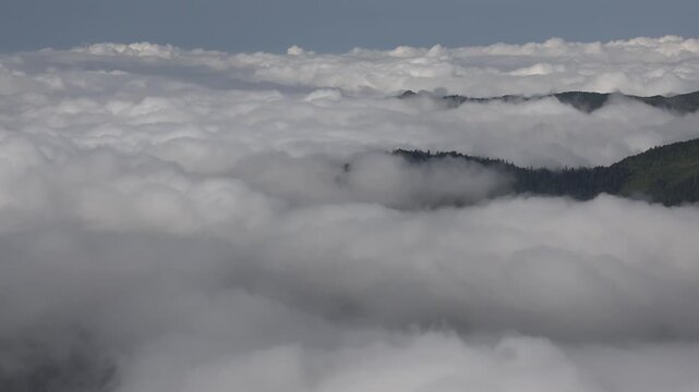 Time lapse aerial view of clouds moving above Bolivian rainforest mountains in wet season. Moody tropical landscape shows fog, mist and fast clouds over Yungas ranges in Bolivia.