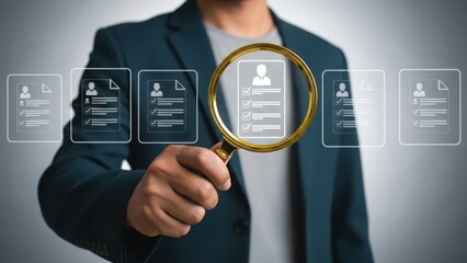 Businessman examining virtual resumes with magnifying glass