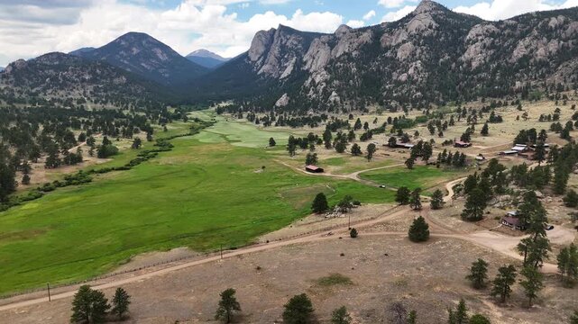 Aerial Drone of approaching Rainstorm in Estes Park Colorado.  Darkening clouds and visible downpour hovers over dramatic mountain landscape.