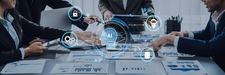 A lively business meeting focused on artificial intelligence integration, featuring a diverse team analyzing data charts with technology icons and digital tools around the table. Trope