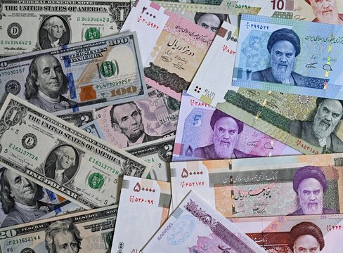 Money background. American dollars and iranian rials banknotes.