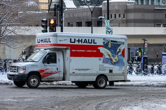 Canada, Montreal, 24 December 2025 : U-Haul truck at snowy intersection with traffic lights visible