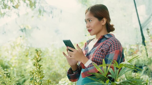 Woman Using Smart phone in Lush Garden