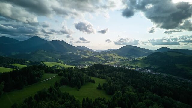 Aerial hyperlapse of idyllic hilly Carpathian landscape with forests and valleys in summer