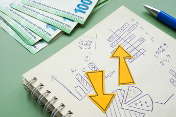 Notebook with financial charts and arrows. Investment risk.