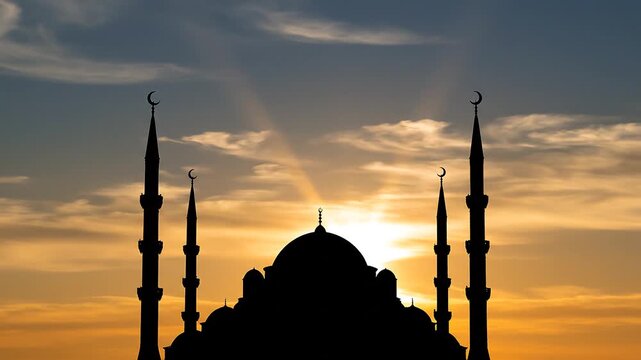 Silhouette of a majestic mosque with minarets at sunset with vibrant orange sky