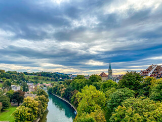Fototapeta premium Scenic Cityscape of Bern with lush Greenery and Historic Architecture