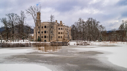Karpniki Palace in Winter, Historic Castle Reflected in Frozen Lake, Poland