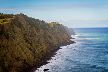 Dramatic coastline with steep green cliffs and Atlantic Ocean in Nordeste, Sao Miguel, Azores.