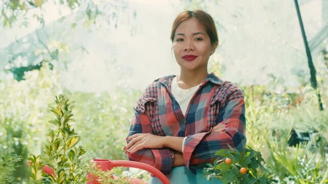 Woman in Greenhouse with Lush Plants
