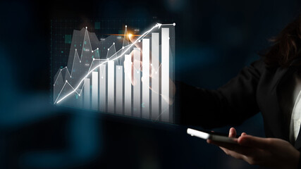 A business professional examines financial data using a smartphone with a digital graph displaying growth trends, encapsulating success and analytics in a modern setting. Impute