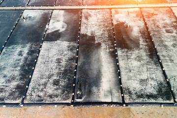 Salt farm, harvesting the salt. Collect salt on the large, flat pans of the farm on a bright, sunny day