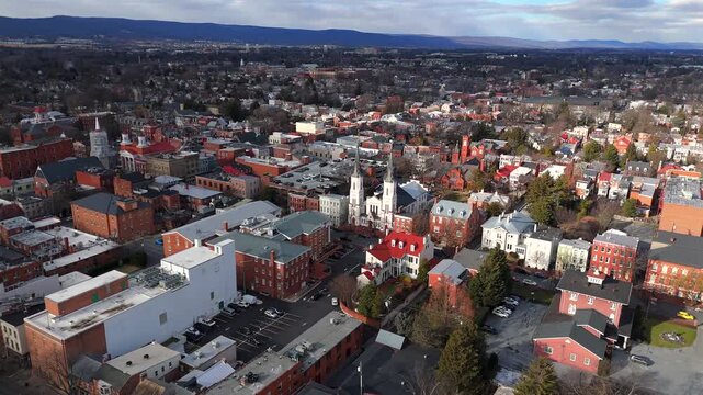 Aerial view of historic church architecture surrounded by town buildings and rooftops in Maryland