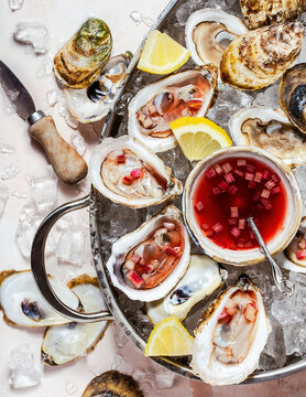 Oysters with mignonette shot overhead on light background. 