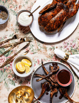 Roast Duck and Lamb Chops with Sauce on Elegant Floral Table Setting