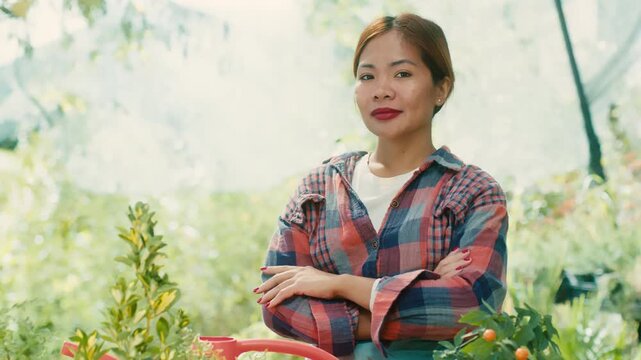 Woman in Greenhouse with Lush Plants