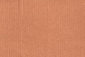 Fototapeta premium Natural brown kraft paper texture background with subtle horizontal grain and recycled fiber details. Minimal cardboard surface ideal for packaging design, eco branding, stationery, mockups, posters.