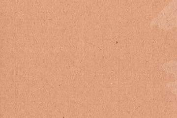 Fototapeta premium Natural brown kraft paper texture background with subtle horizontal grain and recycled fiber details. Minimal cardboard surface ideal for packaging design, eco branding, stationery, mockups, posters.