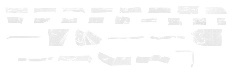 Set of transparent adhesive tape pieces and torn plastic strips isolated on black background....