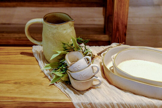 Paris, France, EU  Ceramic measuring cups and pitcher  laid out on a table.
