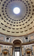 Obraz premium Interior dome of the Pantheon in Rome, ancient Roman temple ceiling with coffered concrete pattern and central oculus opening to the sky, classical architecture landmark and historic monument in Italy