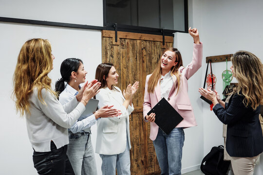 Successful hispanic business women teamwork with different ages working and using laptop at office. Diverse and multi ethnic group of females entrepreneurs and multi generational sharing ideas at work