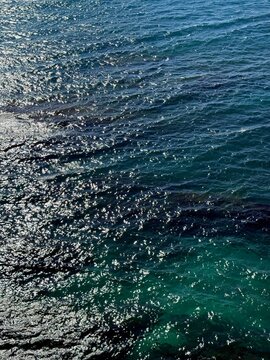 Sea sparkling blue turquoise water vertical.