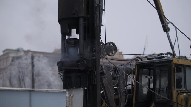 Piling rig drilling foundation pile in winter conditions