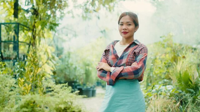 Woman in Greenhouse with Lush Plants
