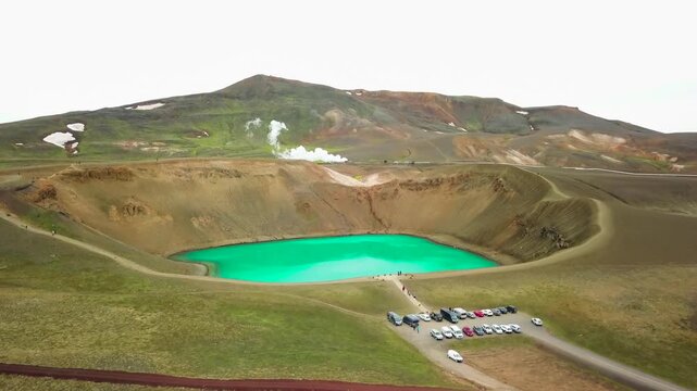 Beautiful drone shot of the Krafla geothermal area in Iceland with green lakes and steaming hot pots.