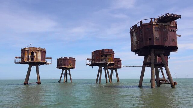 The Maunsell Forts, old World War two structures stand rusting on stilts in the Thames River Estuary in England.