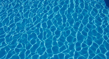 Obraz premium Rippled light shines on clear blue swimming pool water surface on a sunny day