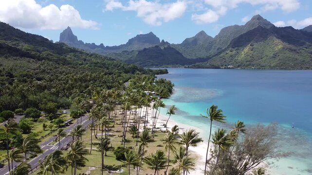 Gliding above Moorea&rsquo;s luminous lagoon, the shoreline unfurls in turquoise ribbons - where coral gardens meet white‑sand arcs and the Pacific shimmers in ever‑changing shades of blue.
