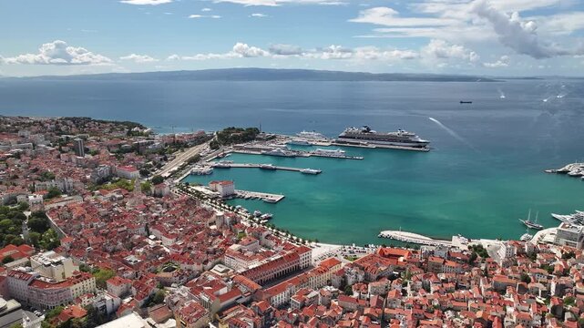 Drone video of Split harbor with boats, ferries, and islands visible across the Adriatic horizon.