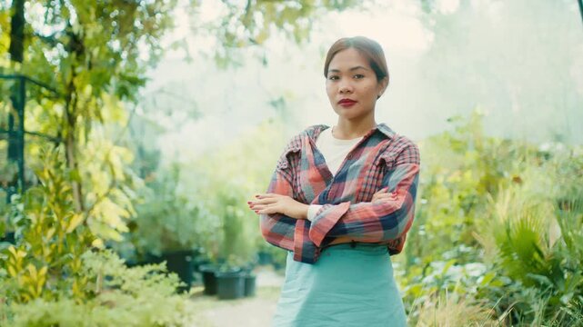 Woman in Greenhouse with Lush Plants