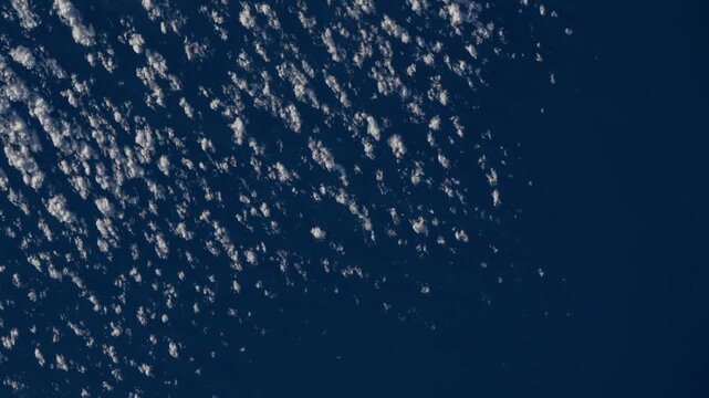 Abstract cloud pattern drifting over deep blue ocean, design background animation based on NASA imagery