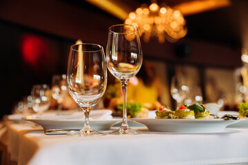 Fototapeta premium Experience diverse dishes from Ukrainian to Japanese cuisine in an elegant dining setting with fine glassware at a restaurant