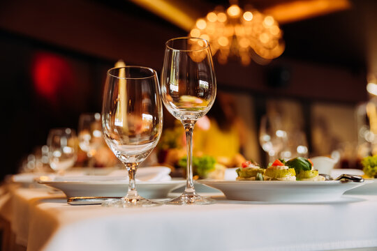 Experience diverse dishes from Ukrainian to Japanese cuisine in an elegant dining setting with fine glassware at a restaurant