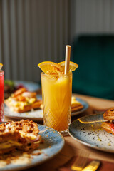 Explore diverse dishes and refreshing drinks from various cuisines at a vibrant dining table full of culinary delights