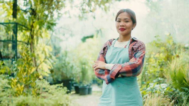 Woman in Greenhouse with Lush Plants