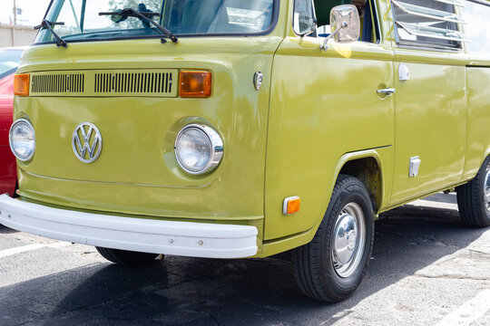 Orlando, Florida, US- January 1, 2026:A 1978 retro-style restored Volkswagen Westfalia van, lime green in color, with a white metal bumper.  The front of the restored vehicle has two round headlights.