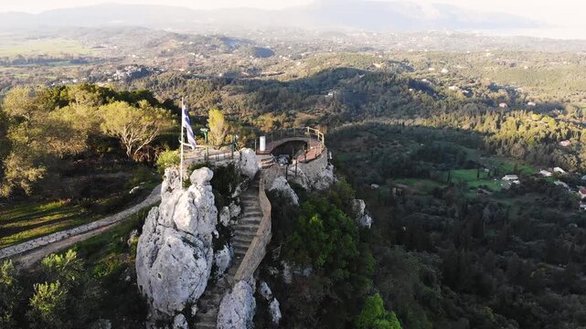 Kaiser's Throne observation deck lookout, Pelekas village, Corfu island, Greece, Kaiser William II summit Observatory panoramic sunny view with mountains, Ionian sea and Kerkyra city in the background