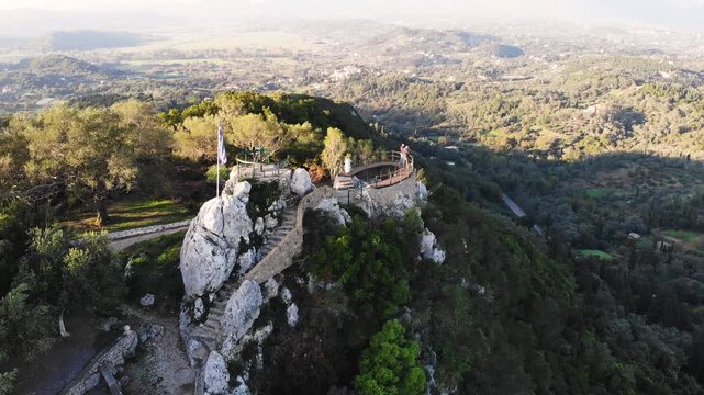 Kaiser's Throne observation deck lookout, Pelekas village, Corfu island, Greece, Kaiser William II summit Observatory panoramic sunny view with mountains, Ionian sea and Kerkyra city in the background