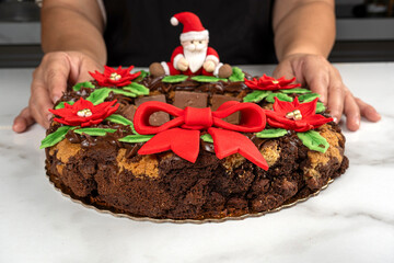 A garland of brownies and cookies with chocolate and a pastry chef in the background.