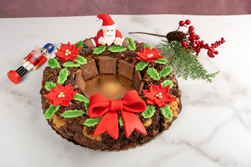 Garland of brownies and cookies with chocolate, placed beside Christmas decorations.
