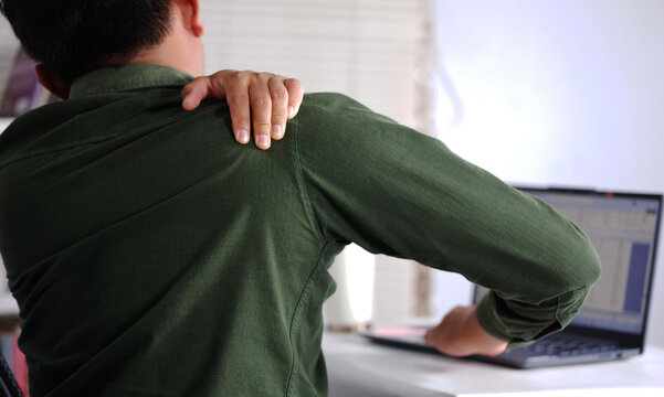 Shoulder pain, a male employee massaging his shoulder due to soreness, overwork. Business, injuries and people with poor posture, inflammation and arm sprains.
