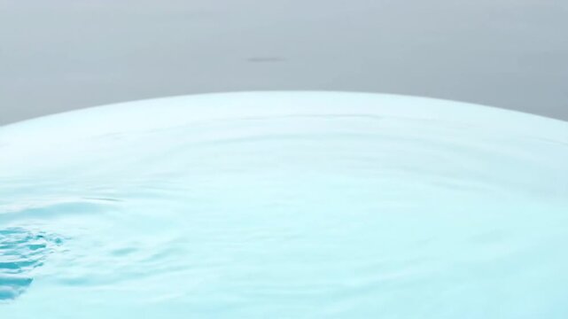 Paddle stroke in calm blue water close up slow motion